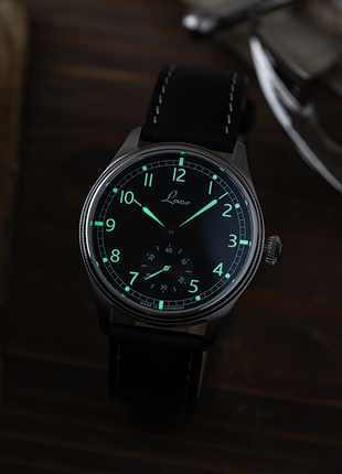 Lume shot of Laco Bremerhaven 39 hand-wound navy watch with black dial, small seconds and black leather strap
