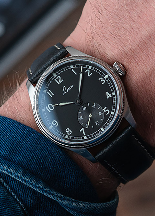 Wristshot of Laco Bremerhaven 39 hand-wound navy watch with black dial, small seconds and black leather strap