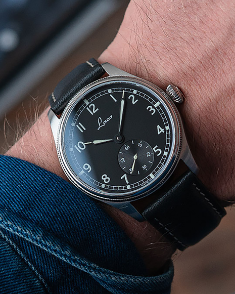 Wristshot of Laco Bremerhaven 39 hand-wound navy watch with black dial, small seconds and black leather strap