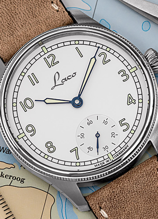 Lifestyle shot of Laco Cuxhaven 42.5 Hand-Wound Navy Watch with white enamel-look dial, small seconds and light-coloured leather strap