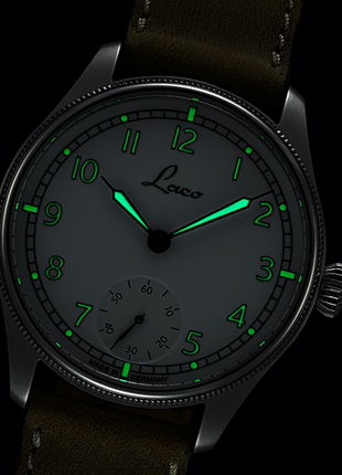 Lume shot of Laco Cuxhaven 42.5 Hand-Wound Navy Watch with white enamel-look dial, small seconds and light-coloured leather strap