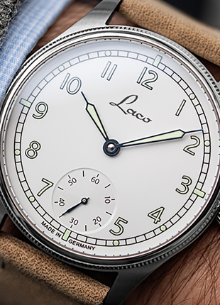 Wristshot of Laco Cuxhaven 42.5 Hand-Wound Navy Watch with white enamel-look dial, small seconds and light-coloured leather strap