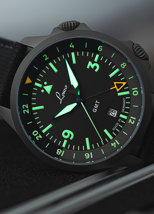 Lume shot of Laco Frankfurt GMT Schwarz black pilot dial with internal GMT bezel and orange 24-hour hand