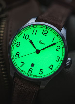 Lume shot of Laco Valencia 39 marine-style dial with black Arabic numerals and hands