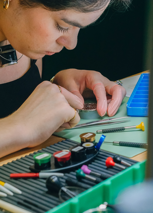 Participant carefully working on a mechanical watch during The Watch Academy Level 1 hands-on watchmaking workshop at Red Army Watches Singapore.