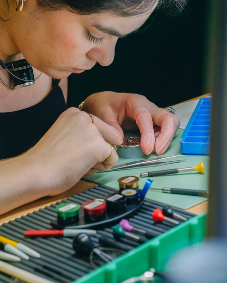 Participant carefully working on a mechanical watch during The Watch Academy Level 1 hands-on watchmaking workshop at Red Army Watches Singapore.