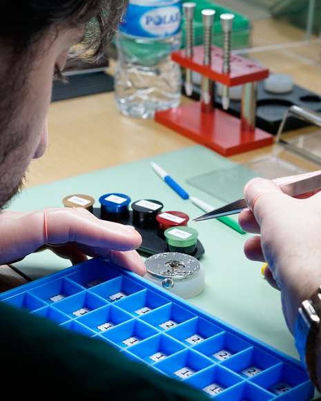 Close-up of a participant using precision tools to work on a mechanical watch movement during The Watch Academy Level 1 workshop.